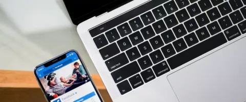 iPhone X beside MacBook