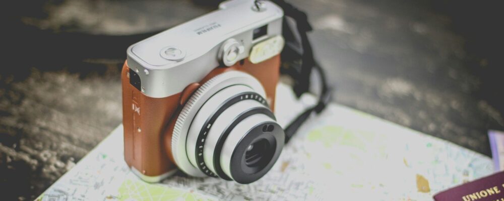 silver point-and-shoot camera on geographical map